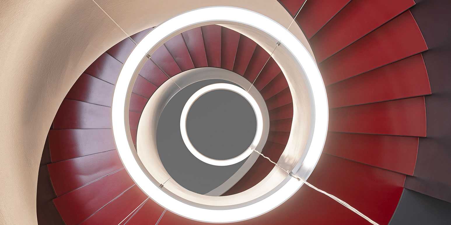 Photo shows red spiral staircase from above